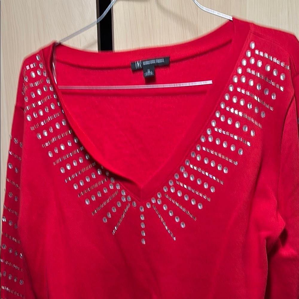 Silver crystals on red sweatsh